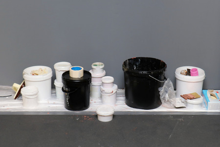 Bucket of paints and other materials used for home renovation work on shelfの写真素材