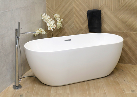 Modern bathtub inside bathroom interior with wooden floor and tilesの写真素材