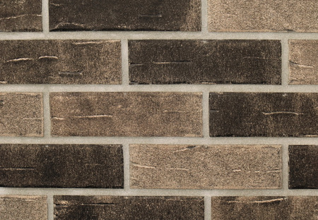 Grainy texture brown bricks wall pattern backgroundの写真素材