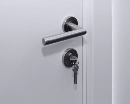 Silver key inside door lock from outsideの写真素材