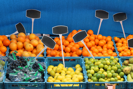 Fresh organic fruits in plastic crates sold on marketの写真素材