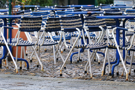 Empty chairs in outdoor cafe outside gardenの写真素材