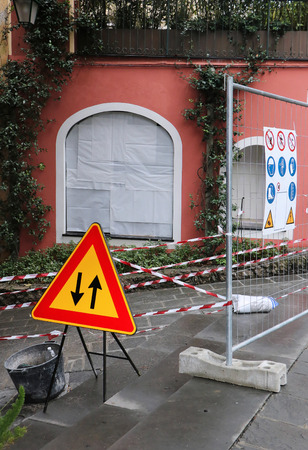 Outdoor construction works with warning signs and safety tapeの写真素材