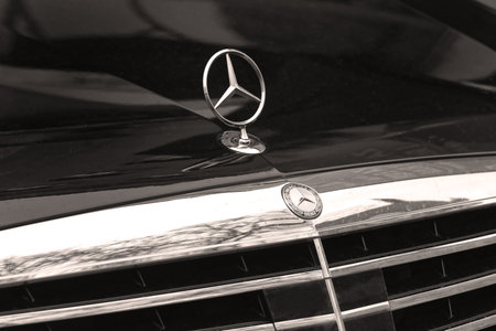 Belgrade, Serbia - February 22, 2018: Recognisable silver Mercedes sign on black car bonnet. Mercedes-Benz is a global German company Daimler AG who is known for luxury vehicles, buses, coaches, and lorries.のeditorial素材