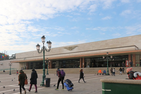 VENICE, ITALY - JANUARY 09, 2017; Santa Lucia train station in Venice Italy with tourists walking with their suitcases on outside square. Santa Lucia is the central station located at the northern edge of Venice's historic city.のeditorial素材