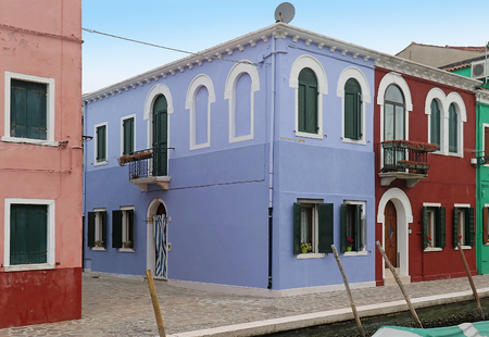 Retro houses with colorful facade walls and closed windowsの写真素材