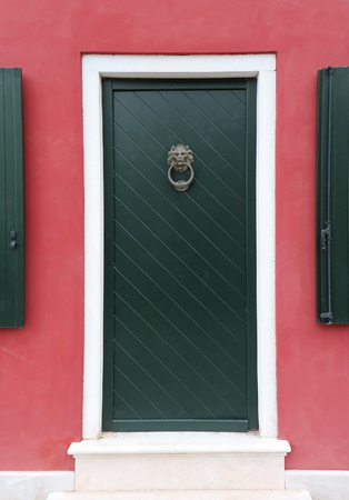 Lion head door knocker on residential entrance doorの写真素材