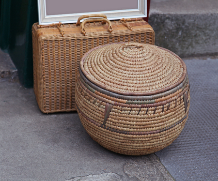 Oriental rattan containers on urban street pavementの写真素材