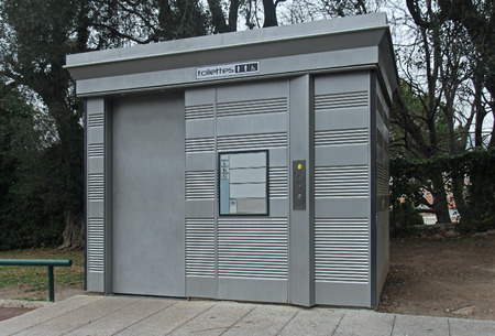 Automatic public toilet facility outside in parkの写真素材
