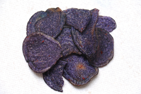 Japanese blue potato chips snack on white napkinの写真素材