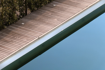 Swimming pool detail with wooden edge inside gardenの写真素材