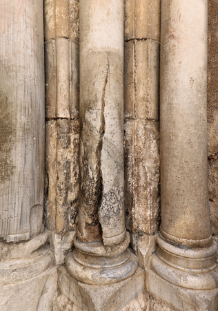 Ancient marble stone damaged columns with cracks and scratchesの写真素材
