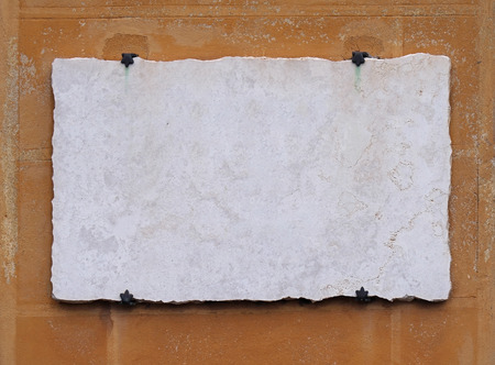 Empty white vintage marble stone plate on grunge wallの写真素材