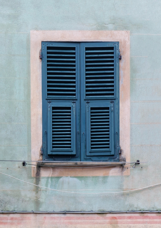 Closed retro window exterior with closed wooden shaftsの写真素材