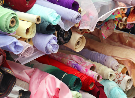 Pile of fashion materials rolls sold on marketの写真素材