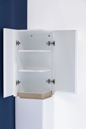 Open wooden corner cabinet with empty shelvesの写真素材