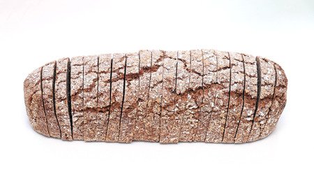 Wholegrain bread loaf sliced into toast pieces on white backgroundの写真素材