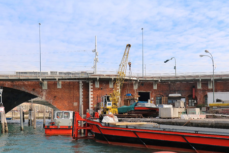 Commercial cargo port with barge and industrial crane in Veniceの写真素材