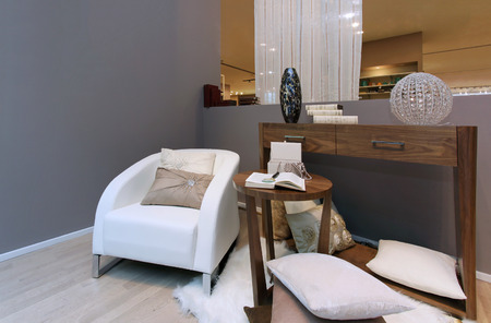 Modern interior corner with armchair and open book on the coffee tableの写真素材