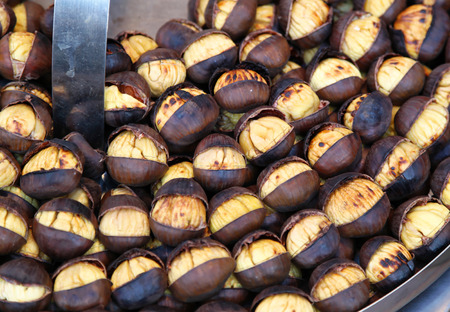 Large organic roasted chestnuts sold as street foodの写真素材