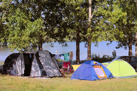 Colorful tents outdoors in the woods in camping siteの写真素材