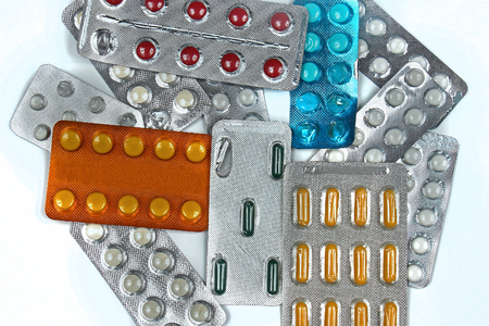 Large pile of colorful prescription pills in silver blistersの写真素材