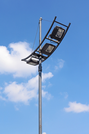 Modern street light with large bulbs on metal pole with sky on backgroundの写真素材