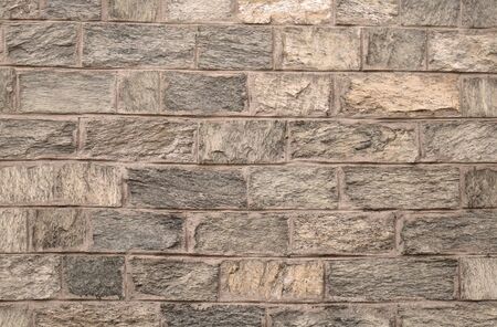 Old beige stone brick pattern background texture