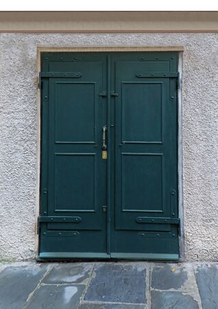 Closed green wooden door on retro house wallの写真素材
