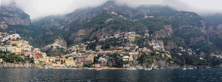 Panoramic image of Amalfi coast seaside with colorful houses and tall mountainsの写真素材