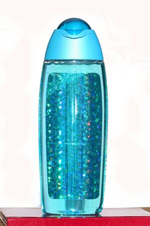 Shower gel with sparkling glitters inside blue plastic bottleの写真素材