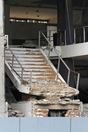 Demolished staircase in modern building after serious earthquakeの写真素材