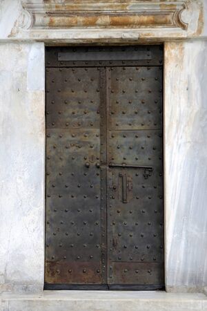 Old closed aged rusty metal door entranceの写真素材