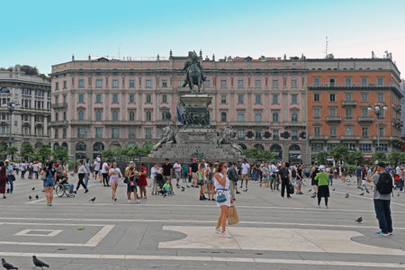 Milan, Italy - June 15, 2019: Large crowd of tourists walking on the square in front of monument statue of Vittorio Emanuele II in Milan near famous landmark Duomo square.のeditorial素材