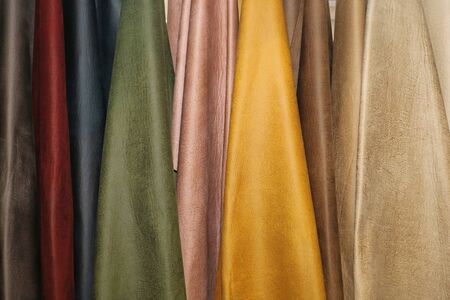 Colorful metallic leather material samples hanging on the wallの写真素材