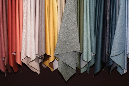 Colorful textile materials samples hanging in fashion factoryの写真素材