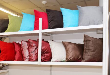 Colorful textile pillows on large shelf interiorの写真素材