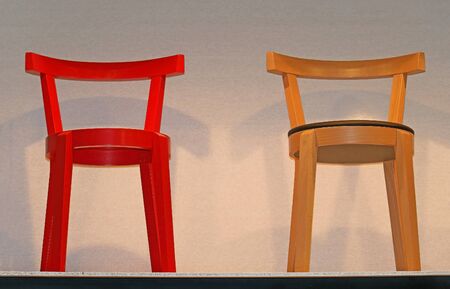 Small wooden retro chairs inside interior wallの写真素材