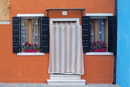 Retro residential entrance door with Christmas decoration on windowsの写真素材