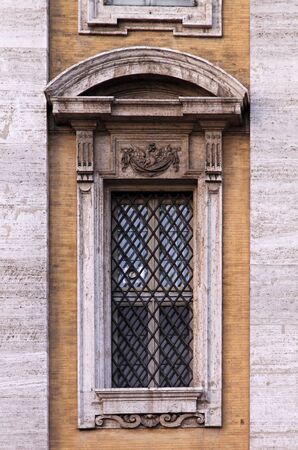 Old window with metal fence on Medieval buildingの写真素材