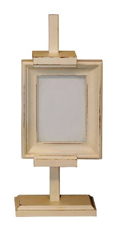 Retro wooden easel with empty small painting frame isolated on whiteの写真素材