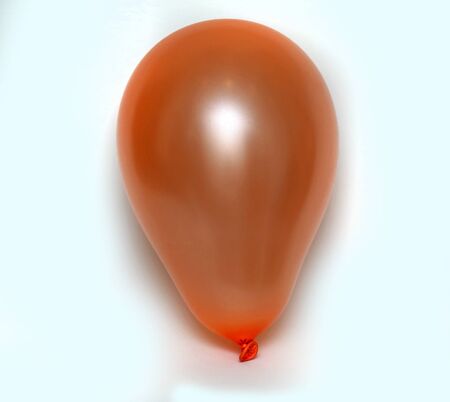 Orange inflated balloon isolated on white backgroundの写真素材