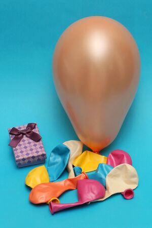 Birthday party accessories with presents and balloons on blue backgroundの写真素材