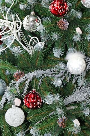 Christmas tree decorated with red bulbs and silver sprinklesの写真素材