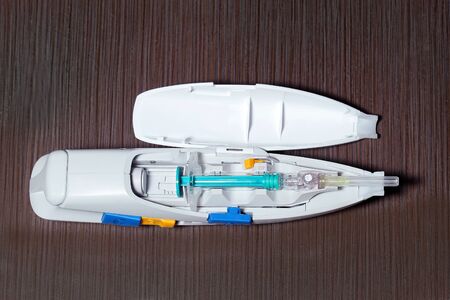 Open auto injector device with injection inserted insideの写真素材