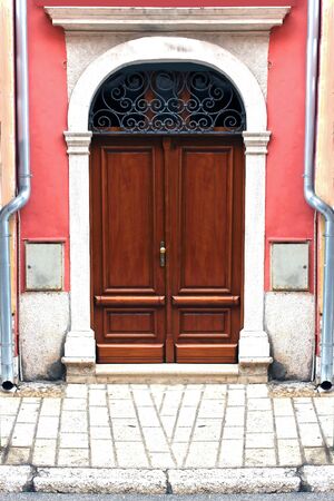 House street entrance with wooden brown closed doorの写真素材