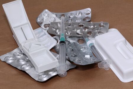 Large pile of empty silver blisters medicine and syringesの写真素材
