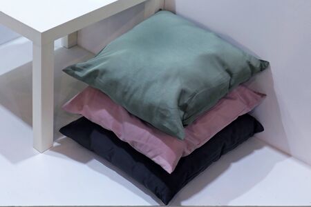Stack of three pillows on the floor interiorの写真素材