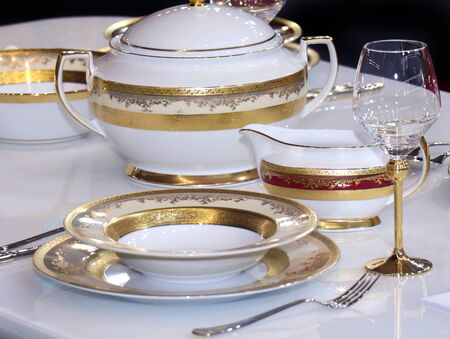 Retro table set with gold plates and bowlの写真素材