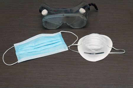 Medical equipment of eye and face masks for health protection on wooden backgroundの写真素材
